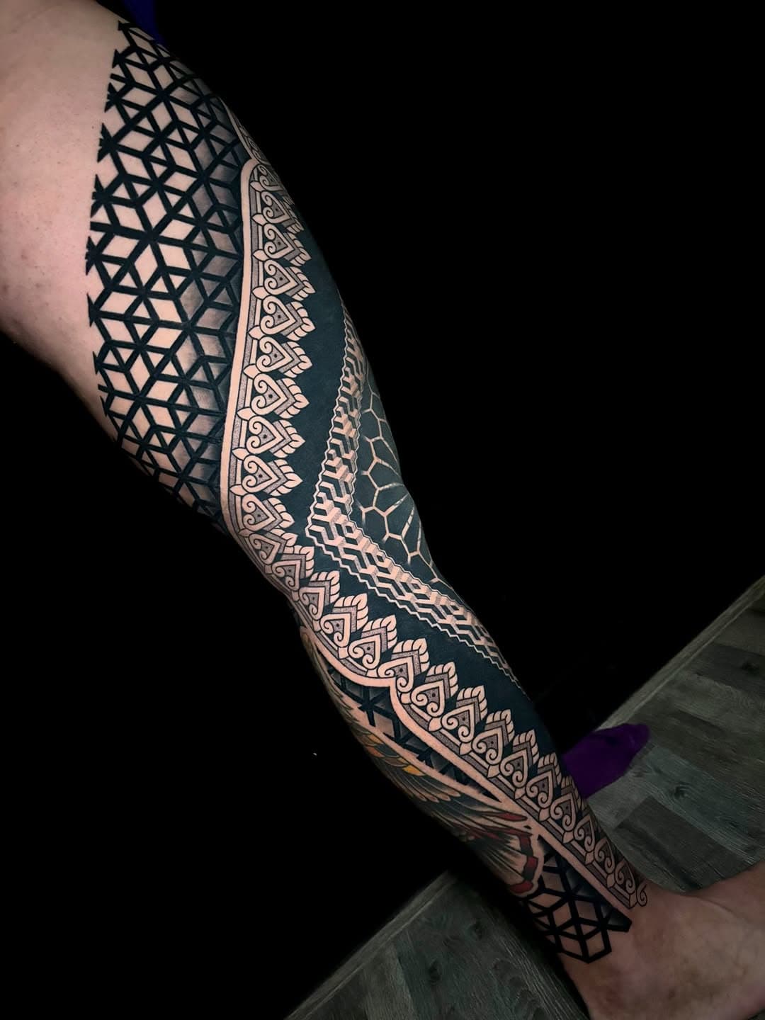 Full leg sleeve tattoo featuring intricate geometric and mandala patterns in blackwork style with detailed line work and symmetrical designs