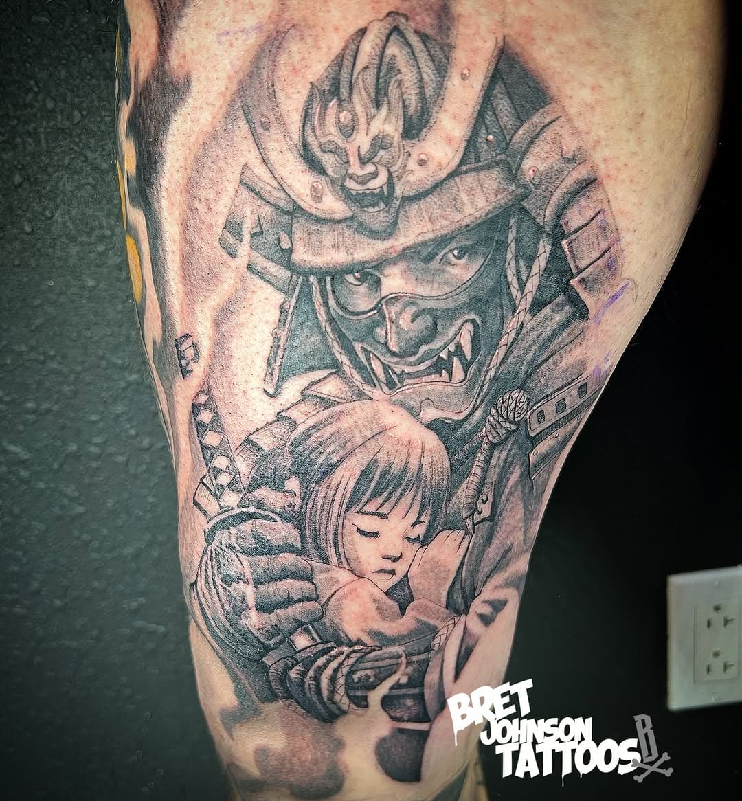 Black and grey Japanese-style tattoo featuring a menacing samurai mask above a young girl with bangs in protective pose