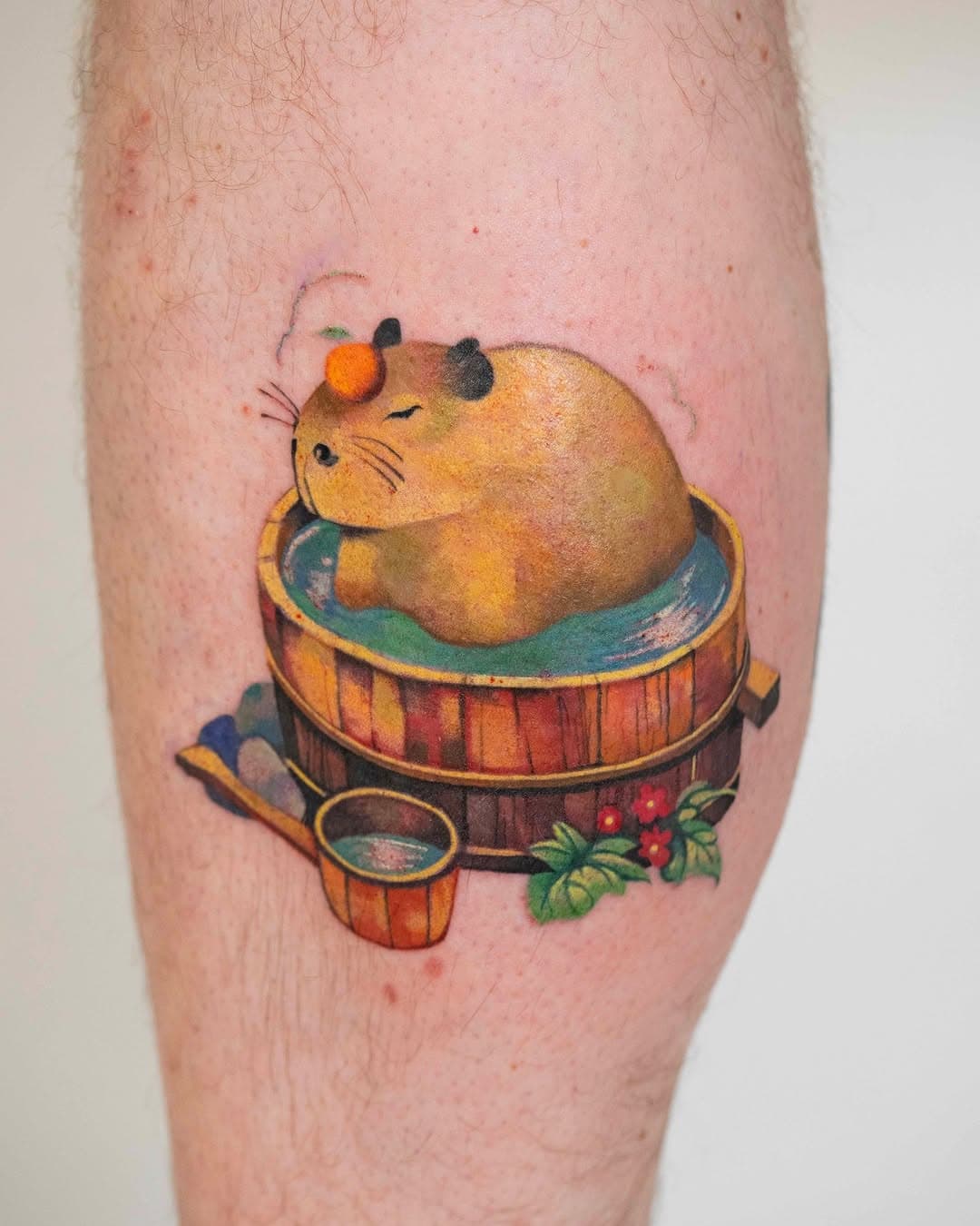 A plump orange capybara relaxing in a wooden barrel bath with teal water, accompanied by a ladle and red berries