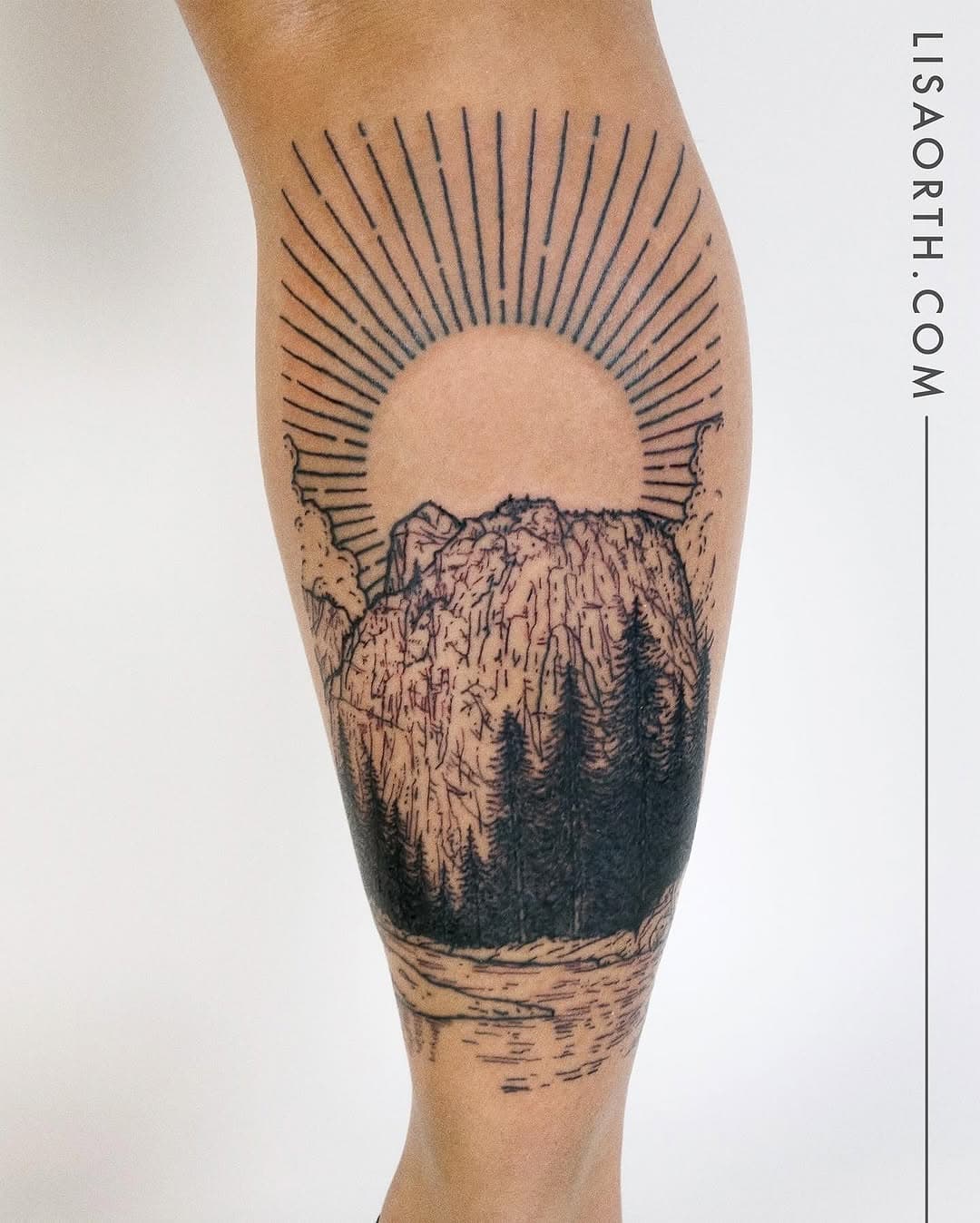 Black fine-line leg tattoo depicting mountains with pine trees in foreground and radiating sun rays above in illustrative style