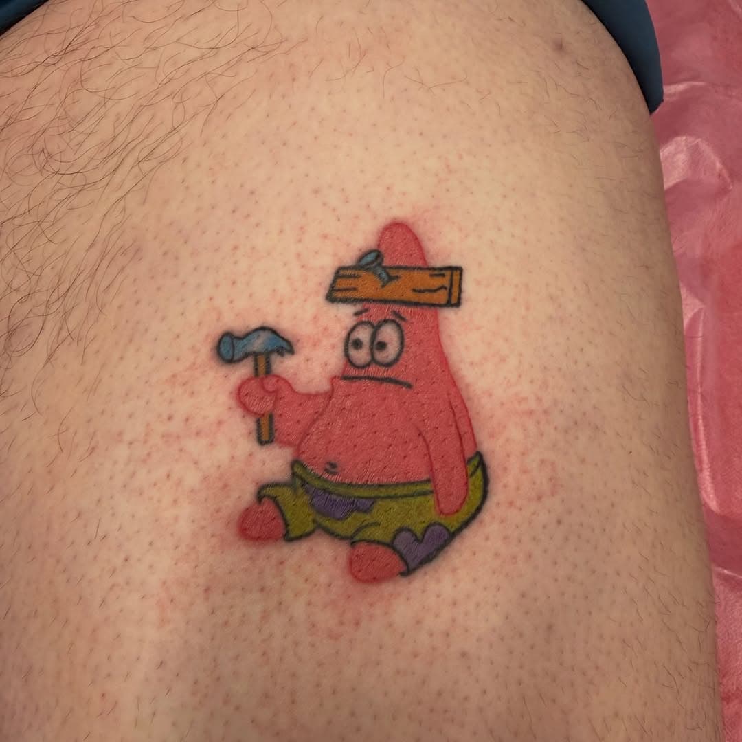 A colorful neo-traditional tattoo of Patrick Star from SpongeBob SquarePants holding a wooden plank on someone's thigh